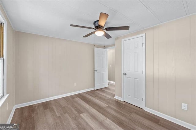 610 Ash Ln, Monroe, GA 30655 - unfurnished bedroom featuring wood finished floors, baseboards, and ceiling fan
