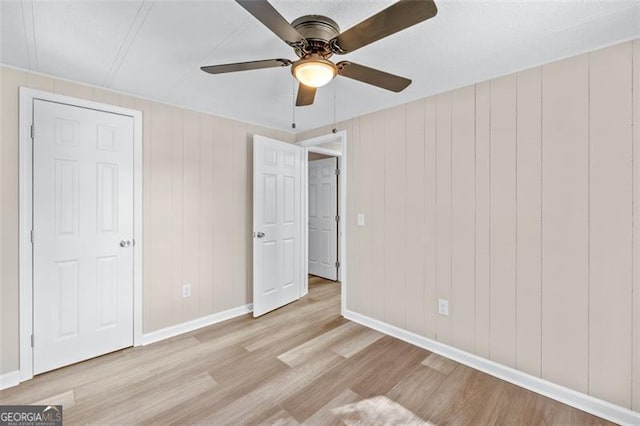 610 Ash Ln, Monroe, GA 30655 - unfurnished bedroom featuring baseboards, wood finished floors, and ceiling fan