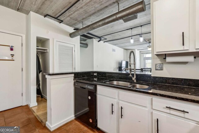 800 Peachtree St NE Unit 2304, Atlanta, GA 30308 - kitchen featuring black dishwasher, tile patterned flooring, white cabinets, and dark stone counters