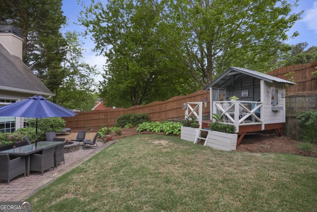 1199 Kenway Cir SE, Smyrna, GA 30082 - view of yard featuring an outdoor fire pit, a patio, and an outdoor structure