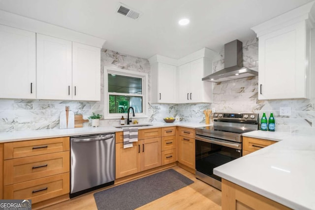 2781 Long Way, Decatur, GA 30032 - kitchen featuring appliances with stainless steel finishes, wall chimney range hood, a sink, and backsplash