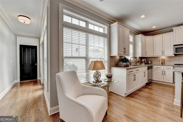 7435 Jamestown Dr, Alpharetta, GA 30005 - kitchen with stainless steel appliances, ornamental molding, backsplash, white cabinetry, and light wood-style floors