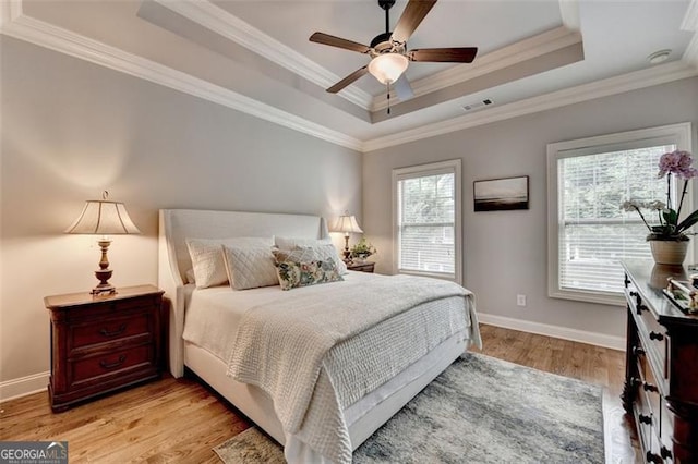 7435 Jamestown Dr, Alpharetta, GA 30005 - bedroom with a tray ceiling, light wood finished floors, crown molding, and a ceiling fan