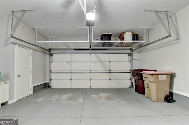 7435 Jamestown Dr, Alpharetta, GA 30005 - garage with baseboards and a garage door opener