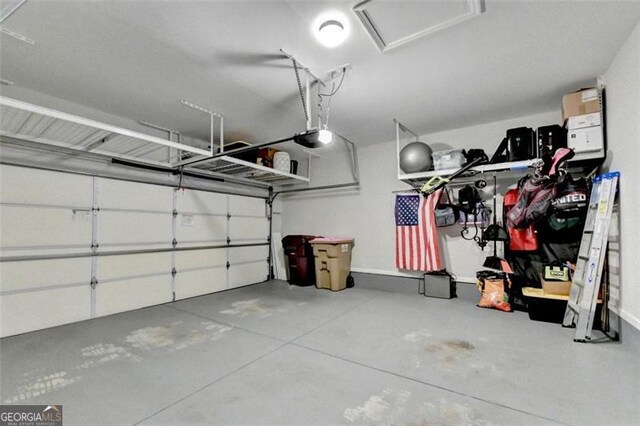 7435 Jamestown Dr, Alpharetta, GA 30005 - garage with a garage door opener and baseboards
