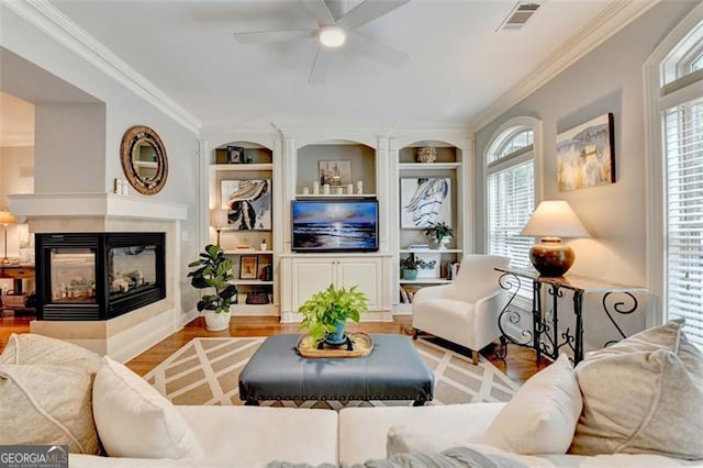 7435 Jamestown Dr, Alpharetta, GA 30005 - living area featuring ceiling fan, wood finished floors, built in features, and ornamental molding