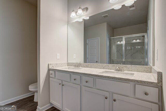 235 Annie Ln, Statham, GA 30666 - full bath with toilet, baseboards, a shower stall, wood finished floors, and double vanity