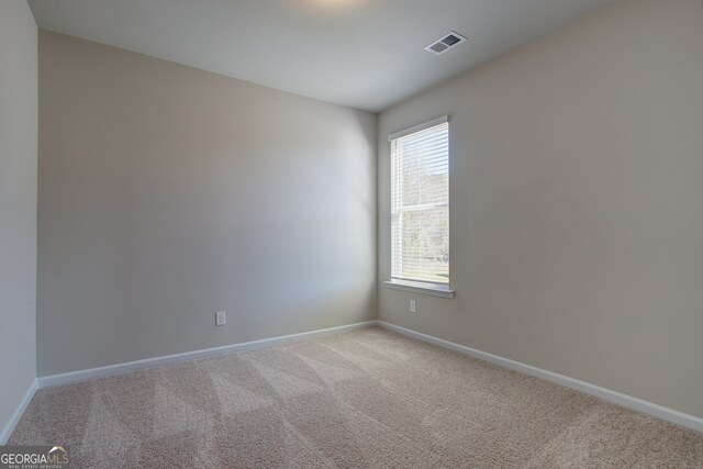 235 Annie Ln, Statham, GA 30666 - spare room featuring light carpet and baseboards