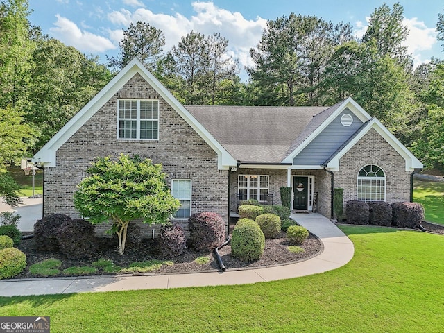 2305 Hawthorne Trce, Monroe, GA 30655 - view of front of property featuring a front yard, brick siding, and roof with shingles