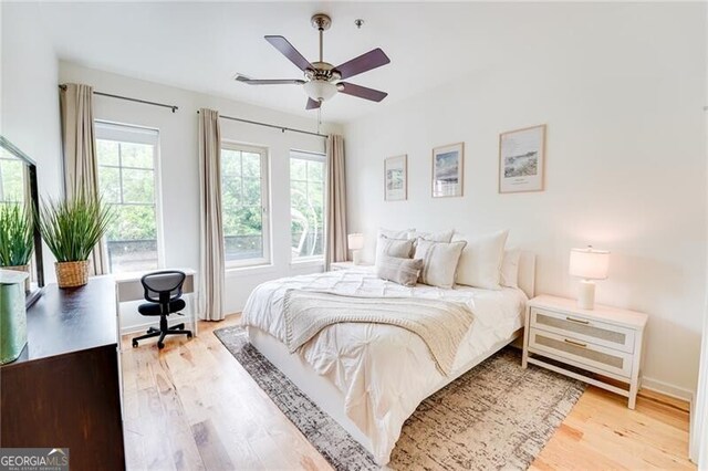 1430 Dresden Dr NE Unit 225, Atlanta, GA 30319 - bedroom featuring wood finished floors, an office area, and a ceiling fan