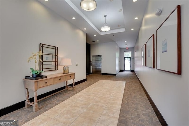 1430 Dresden Dr NE Unit 225, Atlanta, GA 30319 - hallway with recessed lighting, a tray ceiling, tile patterned flooring, baseboards, and carpet flooring