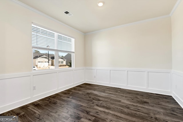 673 Graham Campbell Ln, Statham, GA 30666 - spare room featuring ornamental molding, wainscoting, dark wood-type flooring, and a decorative wall