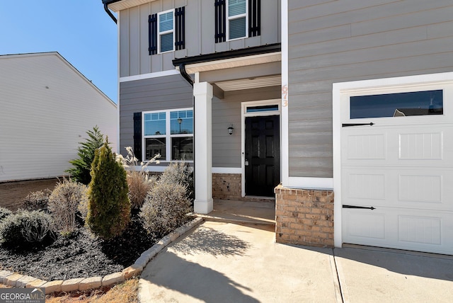 673 Graham Campbell Ln, Statham, GA 30666 - property entrance featuring board and batten siding and a garage