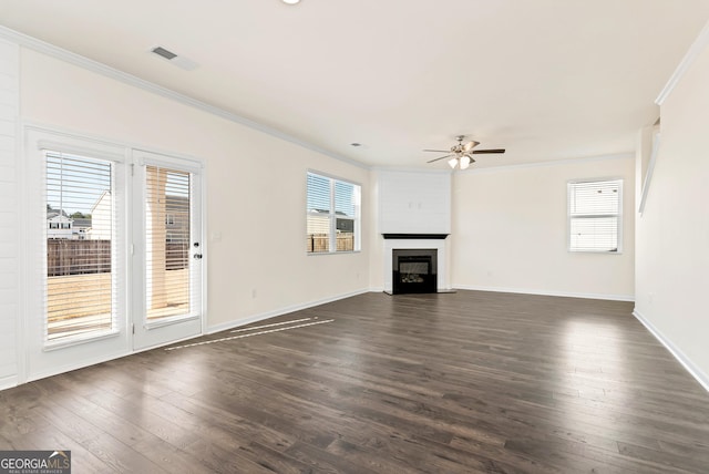 673 Graham Campbell Ln, Statham, GA 30666 - unfurnished living room featuring ornamental molding, a ceiling fan, healthy amount of natural light, dark wood-style flooring, and a glass covered fireplace