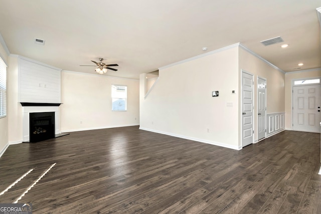 673 Graham Campbell Ln, Statham, GA 30666 - unfurnished living room with crown molding, dark wood finished floors, a ceiling fan, a fireplace with raised hearth, and recessed lighting