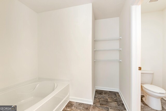 673 Graham Campbell Ln, Statham, GA 30666 - bathroom with a bath and stone finish flooring