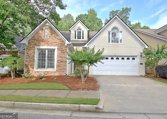 44 Arbor Way, Newnan, GA 30265 - traditional home featuring driveway, brick siding, a garage, and stucco siding