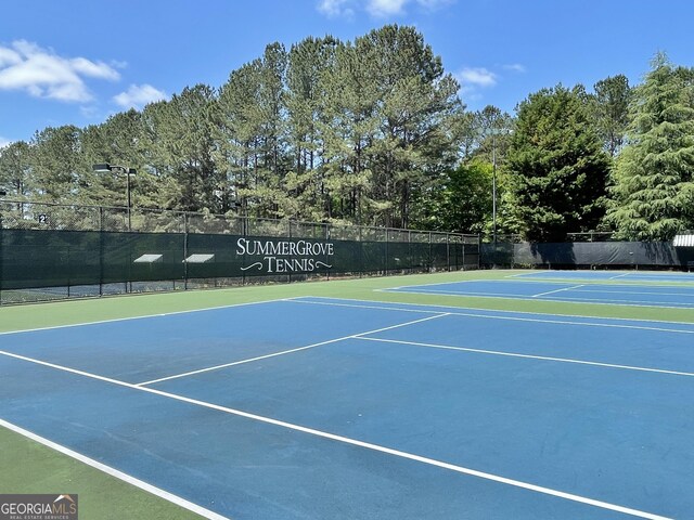 44 Arbor Way, Newnan, GA 30265 - view of tennis court featuring community basketball court, fence, and view of scattered trees