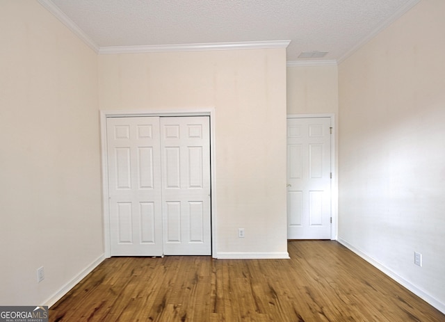 44 Arbor Way, Newnan, GA 30265 - unfurnished bedroom featuring ornamental molding, wood finished floors, baseboards, and a closet