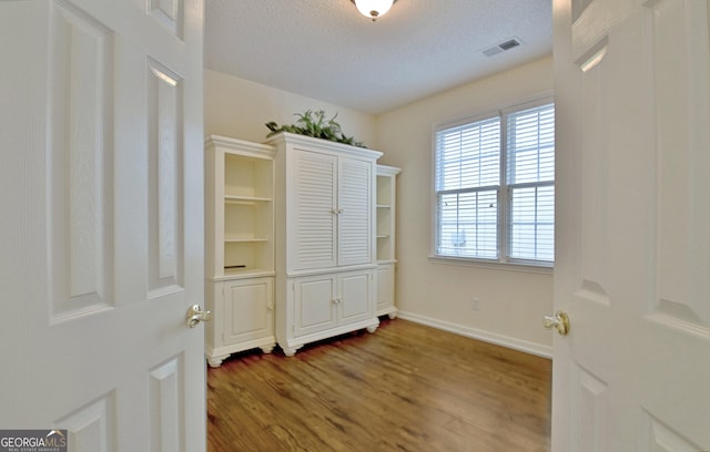 44 Arbor Way, Newnan, GA 30265 - empty room with wood finished floors, baseboards, and a textured ceiling