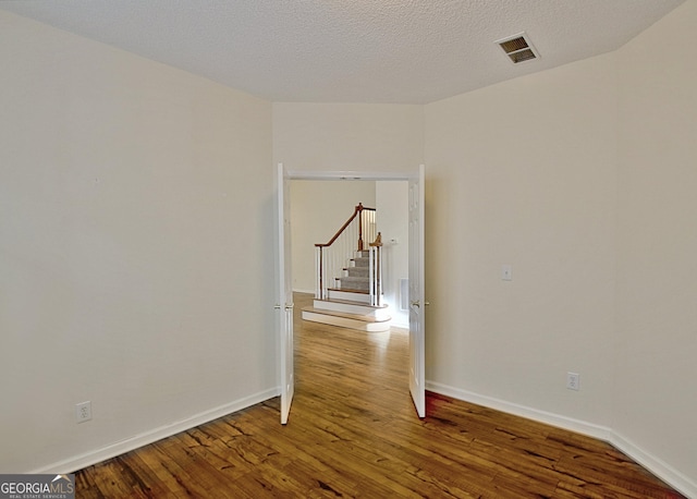 44 Arbor Way, Newnan, GA 30265 - spare room with wood finished floors, baseboards, and stairs