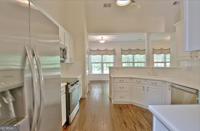 44 Arbor Way, Newnan, GA 30265 - kitchen with appliances with stainless steel finishes, a sink, healthy amount of natural light, and white cabinets