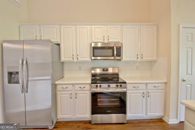 44 Arbor Way, Newnan, GA 30265 - kitchen with stainless steel appliances, light countertops, decorative backsplash, and white cabinetry