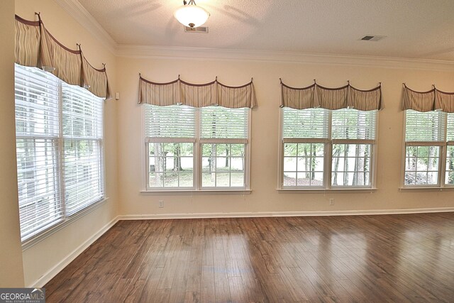 44 Arbor Way, Newnan, GA 30265 - empty room featuring dark wood finished floors, ornamental molding, baseboards, and a textured ceiling