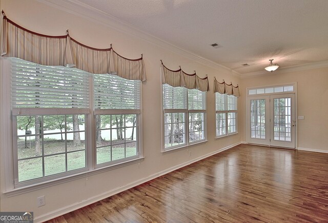 44 Arbor Way, Newnan, GA 30265 - spare room with wood finished floors, ornamental molding, baseboards, and a textured ceiling