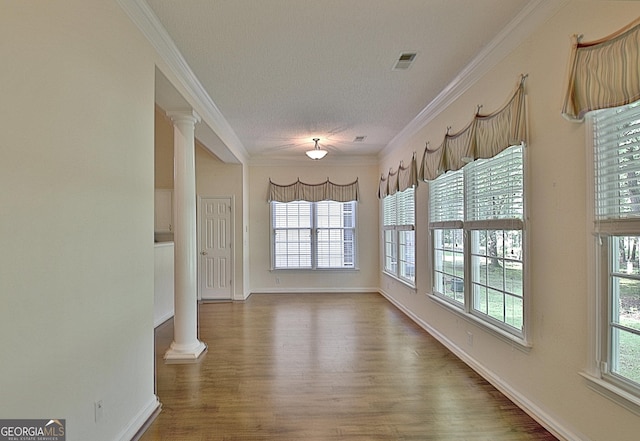 44 Arbor Way, Newnan, GA 30265 - empty room with ornate columns, crown molding, wood finished floors, and baseboards