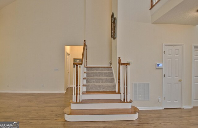 44 Arbor Way, Newnan, GA 30265 - stairs with wood finished floors, baseboards, and a high ceiling