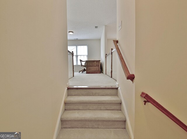 44 Arbor Way, Newnan, GA 30265 - staircase featuring carpet flooring, baseboards, and a textured ceiling