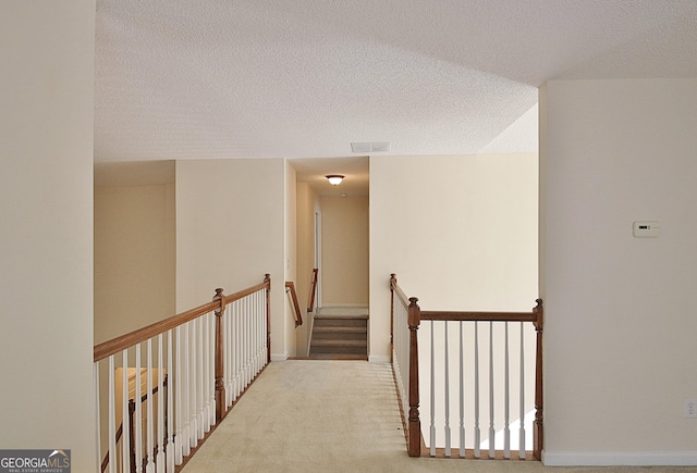 44 Arbor Way, Newnan, GA 30265 - corridor featuring a textured ceiling, an upstairs landing, and carpet floors