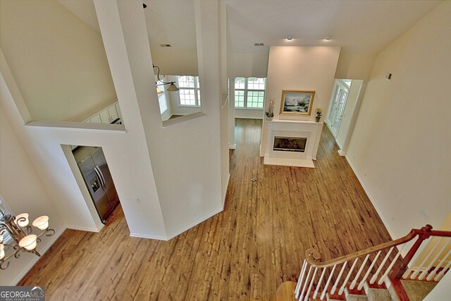 44 Arbor Way, Newnan, GA 30265 - unfurnished living room with a fireplace, wood finished floors, baseboards, and a high ceiling
