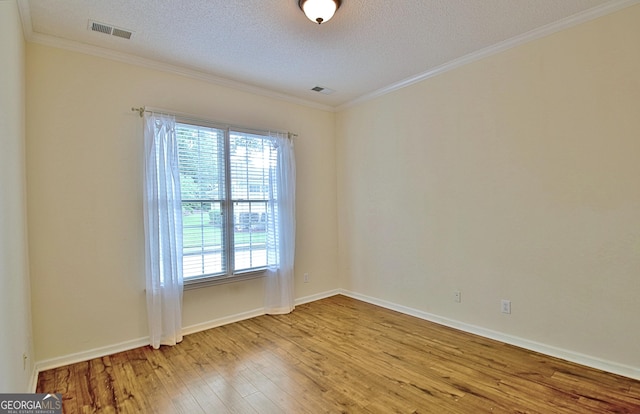 44 Arbor Way, Newnan, GA 30265 - unfurnished room with light wood finished floors, ornamental molding, a textured ceiling, and baseboards