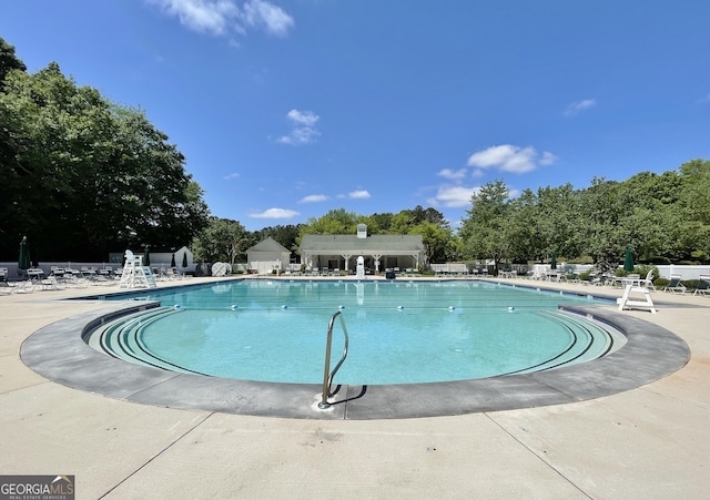 44 Arbor Way, Newnan, GA 30265 - community pool featuring a patio area and view of wooded area