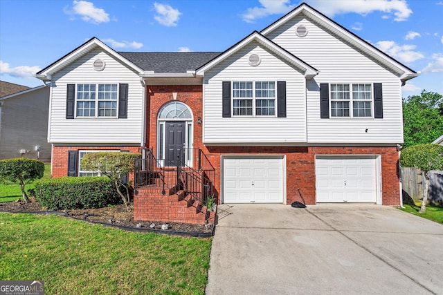 995 Chimney Trace Way, Lawrenceville, GA 30045 - bi-level home featuring brick siding, a garage, driveway, and a front lawn
