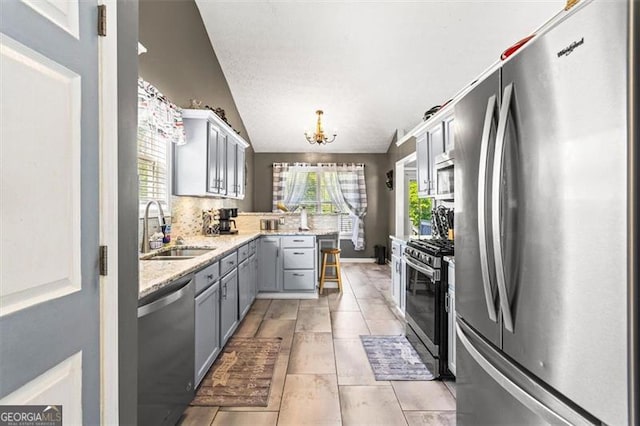 995 Chimney Trace Way, Lawrenceville, GA 30045 - kitchen featuring appliances with stainless steel finishes, gray cabinets, a peninsula, a chandelier, and light tile patterned floors