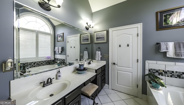 bathroom featuring a garden tub, double vanity, tile patterned flooring, and baseboards