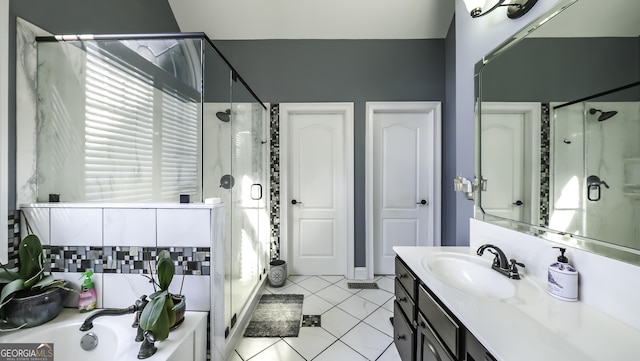 bathroom with a stall shower, vanity, tile patterned floors, and a garden tub