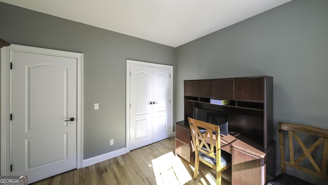 office space with wood finished floors and baseboards