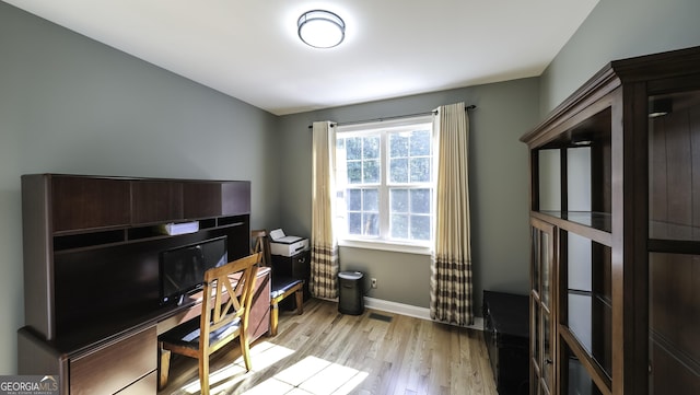 office space featuring light wood finished floors and baseboards