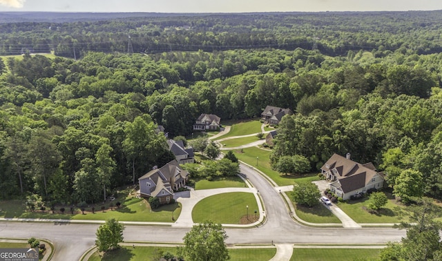 view of property location with a heavily wooded area