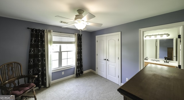 carpeted bedroom featuring baseboards, a closet, and a ceiling fan