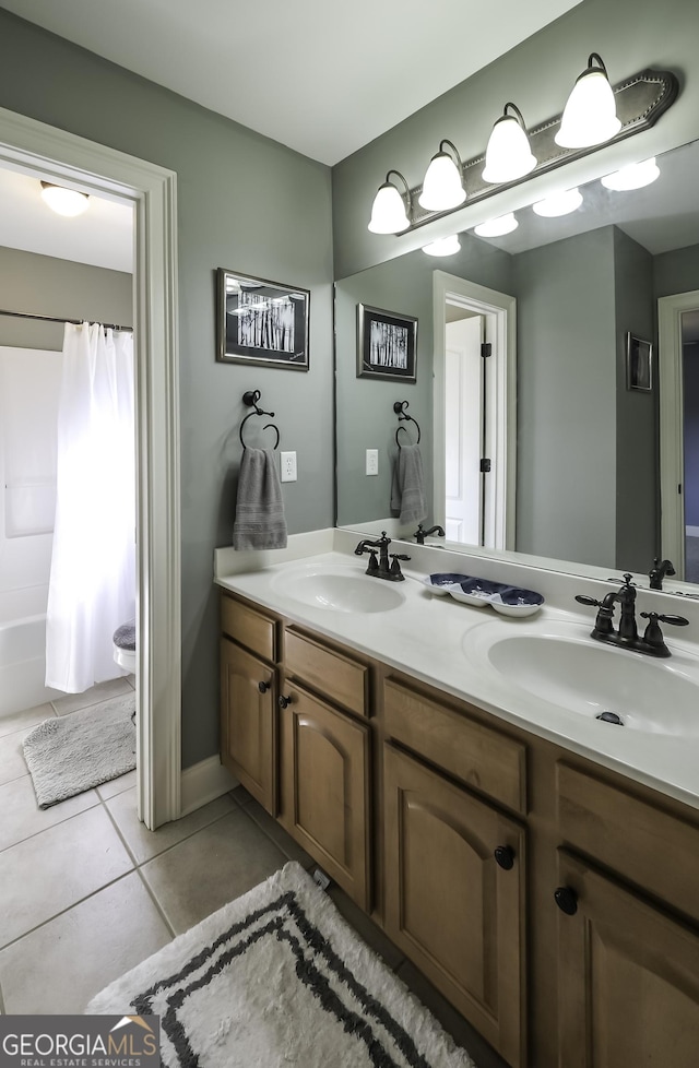 full bathroom with tile patterned floors, double vanity, and shower / tub combo