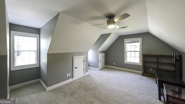 bonus room featuring carpet flooring, lofted ceiling, a ceiling fan, and baseboards