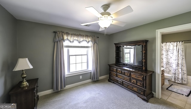 bedroom with carpet flooring, baseboards, ensuite bath, and ceiling fan