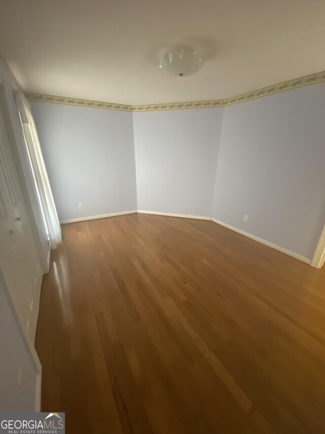 1669 Azalea Dr, Lawrenceville, GA 30043 - spare room featuring wood finished floors and baseboards