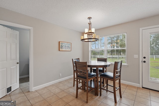 194 Retreat Pl, Woodbine, GA 31569 - dining room featuring a chandelier, light tile patterned flooring, and a textured ceiling