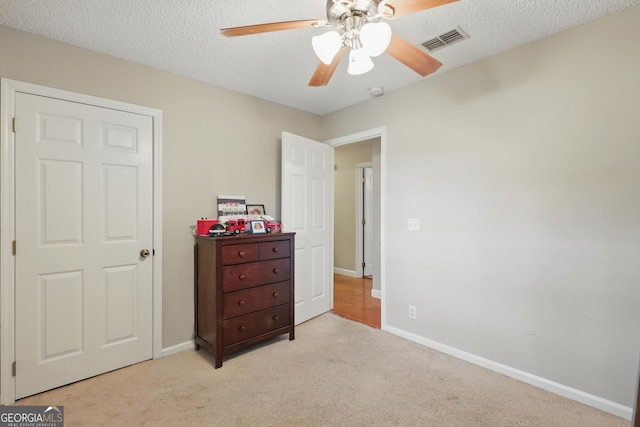 194 Retreat Pl, Woodbine, GA 31569 - bedroom featuring light carpet, a textured ceiling, and a ceiling fan